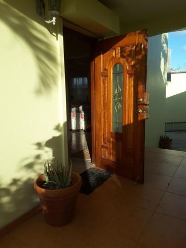 a wooden door with a potted plant in front of it at Bay View condo in Philipsburg