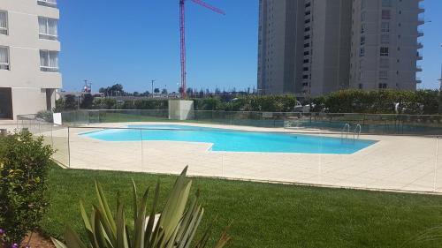 a swimming pool in the middle of a building at Marina Sol 310 in Coquimbo
