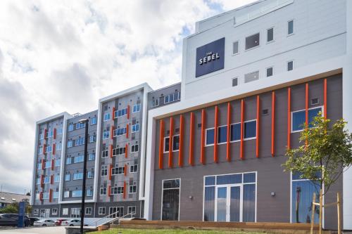 an apartment building with orange and gray at The Sebel Auckland Manukau in Auckland