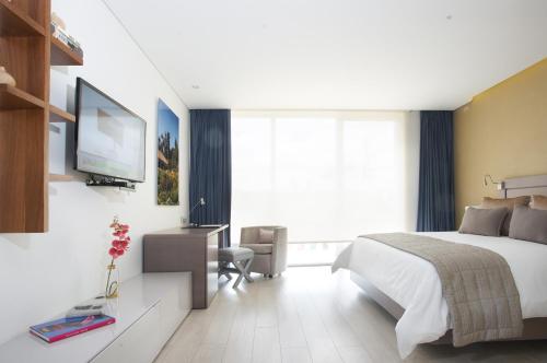 Postel nebo postele na pokoji v ubytování Hotel 100 Luxury Suites by Preferred