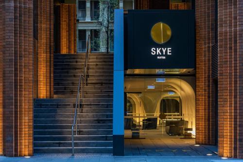 a building with a sign for a style store at SKYE Suites Sydney in Sydney