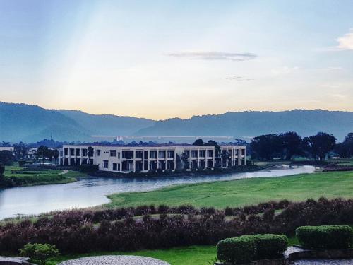 a large white building next to a river at The Midst@ Royal hills Nakornayok in Nakhon Nayok
