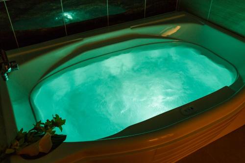 a jacuzzi tub in a bathroom with aperature at HOTEL MYTH-Resort -ホテル マイス リゾート- adult only in Nagato