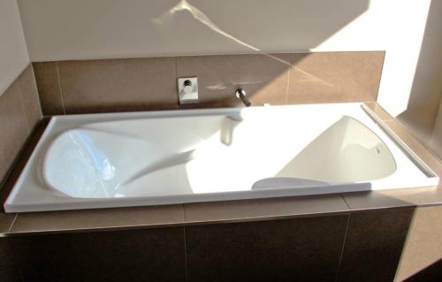 a white tub with a faucet in a bathroom at Apartment on Stansell in Nelson