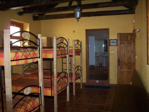 a room with three bunk beds in a room at Albergue Estrella Del Camino in Frómista