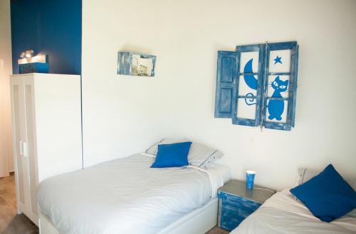 a bedroom with two beds with blue pillows at Casa Rural Txokoetxe in Mungia