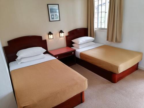 Postel nebo postele na pokoji v ubytování Kinabalu Pine Resort