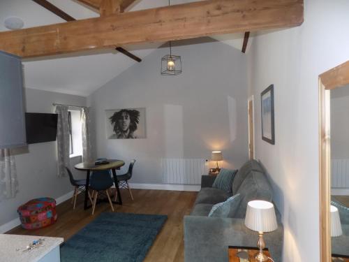 a living room with a couch and a table at The Old Wool House Apartments in Carlisle