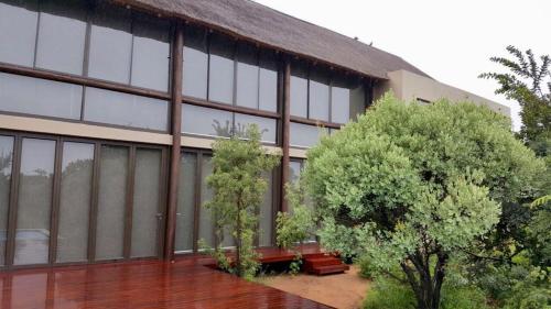 a building with windows and benches in front of it at Kuwisa Lodge in Bela-Bela