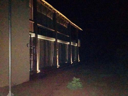 a building at night with the lights on at Kuwisa Lodge in Bela-Bela