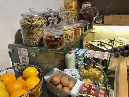 a counter with many jars of nuts and fruits at FastHôtel Biarritz Bidart Côte-Basque - Un hôtel FH Collection in Bidart