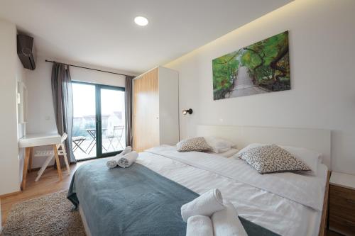 a bedroom with a large bed and a large window at Villa Privlaka in Privlaka