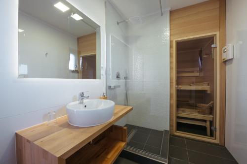 a bathroom with a white sink and a shower at Villa Privlaka in Privlaka