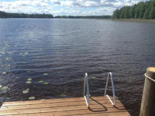 a dock on a lake with a chair on it at Holiday Home Jokela by Interhome in Horonkylä
