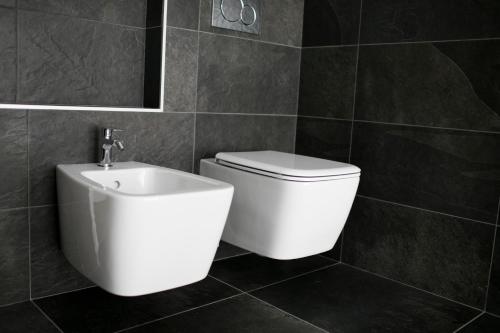 a bathroom with a white toilet and a sink at Country House Villa Barbero in Mango