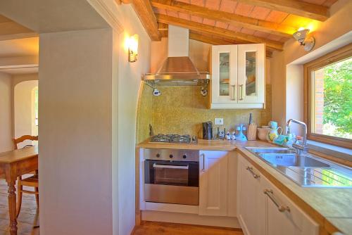 a kitchen with a sink and a stove at Gellino by PosarelliVillas in Misciano