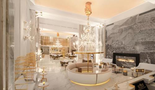a living room with a chandelier and a fireplace at Epirus Palace Congress & Spa in Ioannina