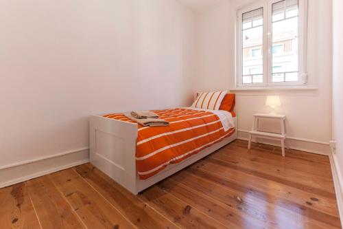 a small bedroom with a bed and a window at Apartment in Center of Lisbon in Lisbon
