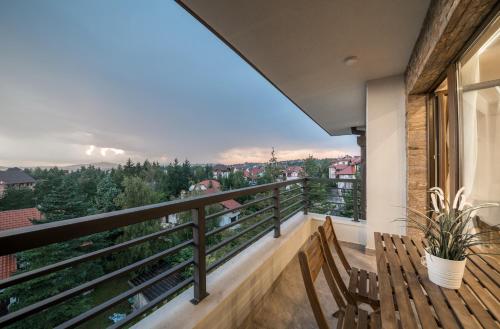 a balcony with a bench and a view at Vip Casa Club Zlatibor in Zlatibor