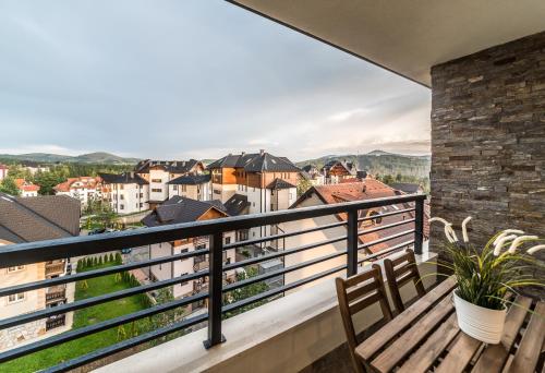 a balcony with a bench and views of a city at Vip Casa Club Zlatibor in Zlatibor