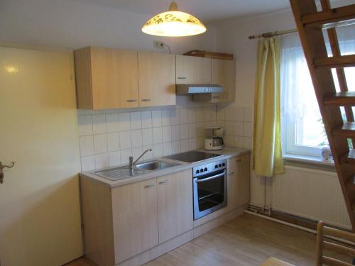 a kitchen with a sink and a stove and a window at Modern Holiday Home in Boitin Germany near Lake in Boitin