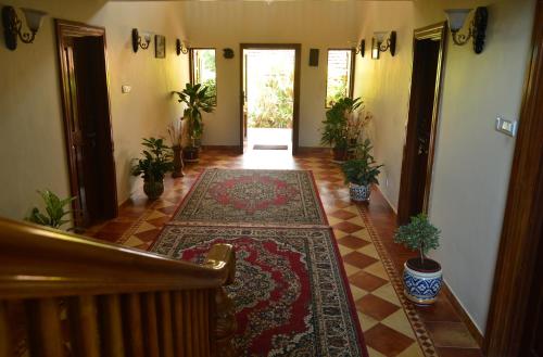 a hallway with rugs on the floor in a house at Palm Grove Cottages - Leisure Resort in Benaulim