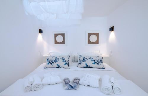 a bed with blue and white pillows and towels at Eden View Suites & Villas in Paradise Beach