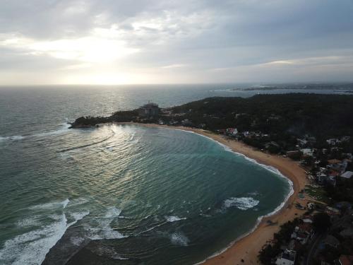 an aerial view of a beach and the ocean at Hotel Panorama in Unawatuna