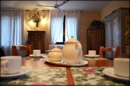 a dining room table with a tea pot on top of it at B&B Al Ponte in Padova