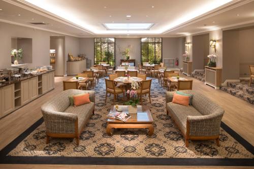 a hotel lobby with tables and chairs and a restaurant at Le Littré in Paris