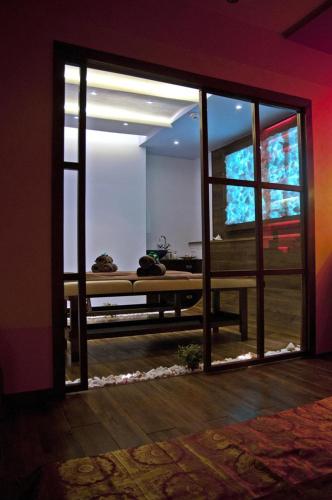 a room with a sliding glass door with a bed outside at Galaxy Hotel in Kraków
