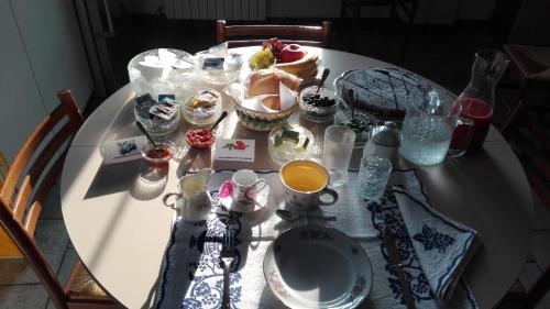 a white table with food and drinks on it at Casina Belvedere in Casalecchio di Reno