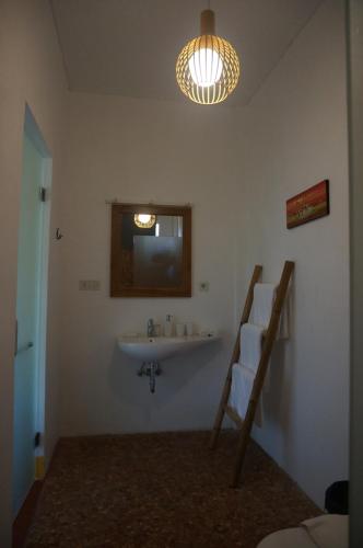 a bathroom with a sink and a mirror at Manggis Garden Dive Resort in Candidasa