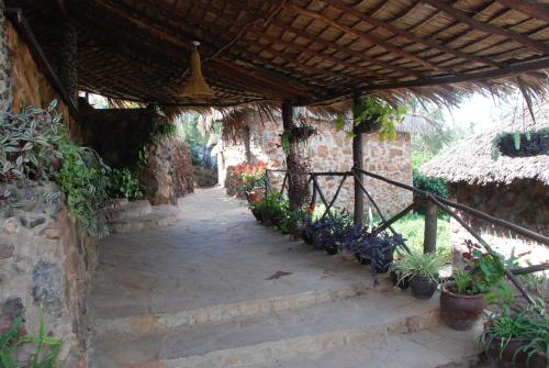 an outdoor walkway with a wooden roof and plants at Osoita Lodge in Nairobi