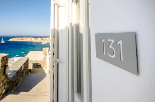 a clock on the side of a window with a view at Eden View Suites & Villas in Paradise Beach