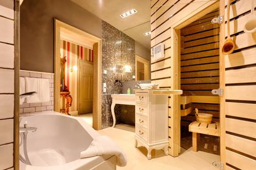 a bathroom with a tub and a sink at Bio-Apartments Villa Thusnelda in Bad Schandau