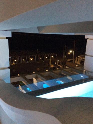 a view of a swimming pool at night at Agios Gordios Beach Resort in Agios Gordios