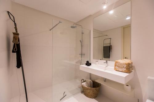 a white bathroom with a sink and a shower at Apartment Atalaya Hills en Benahavís Marbella Golf in Estepona