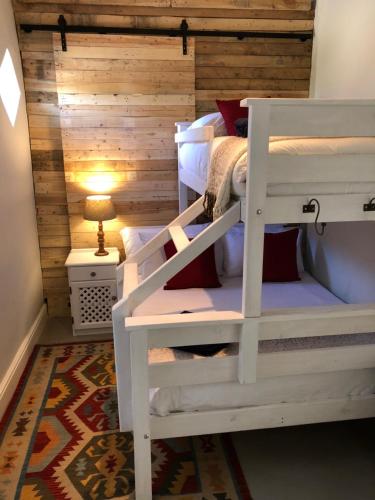 a bunk bed room with two bunk beds and a lamp at The Lemon Tree in Prince Albert