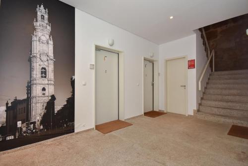 an empty room with stairs and a picture of a tower at Urban Apartment Casa da Portela in Porto