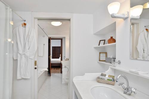 a bathroom with a sink, mirror, and bathtub at Hotel San Lorenzo - Adults Only in Palma de Mallorca