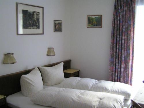 a living room with a white couch and a window at Haus Fallesin in Sankt Anton am Arlberg