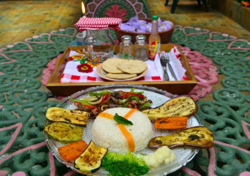 a plate of food with vegetables on a table at Hotel Oasis in San Salvador