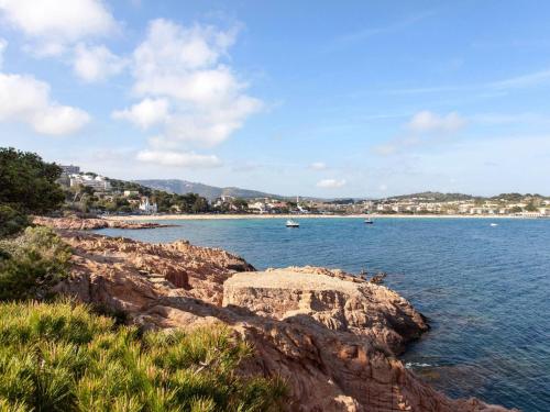 a view of a body of water with a rocky shore at Holiday Home Gramoia by Interhome in S'Agaro