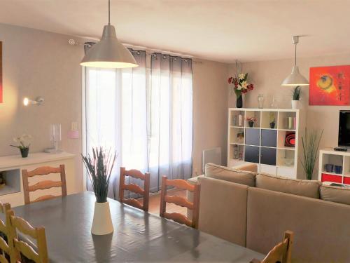 a kitchen and living room with a table and a couch at Holiday Home Roumagnac by Interhome in Cavalaire-sur-Mer