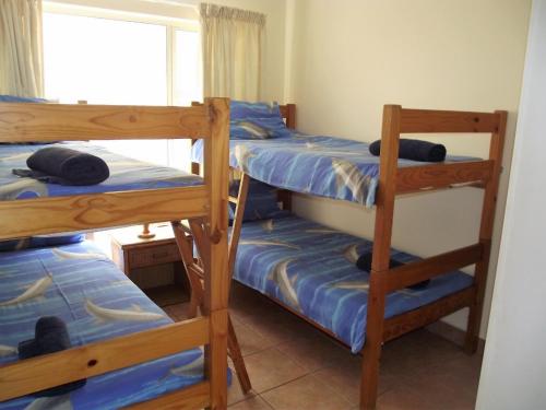 a bedroom with two bunk beds and a window at Ramsgate Palms J in Ramsgate