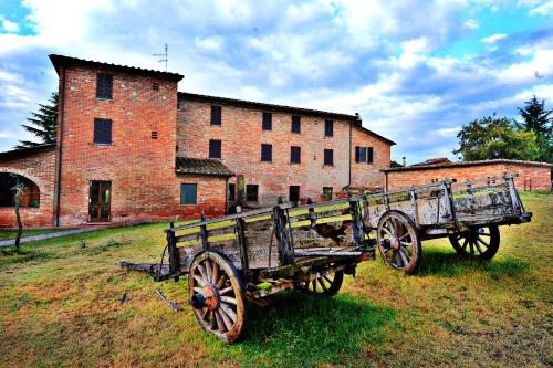 an old horse drawn carriage in front of a building at Albergo La Foresteria in Bettolle
