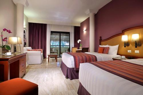 a hotel room with two beds and a couch at Family Selection at Grand Palladium Vallarta Resort & Spa - All Inclusive in Punta Mita