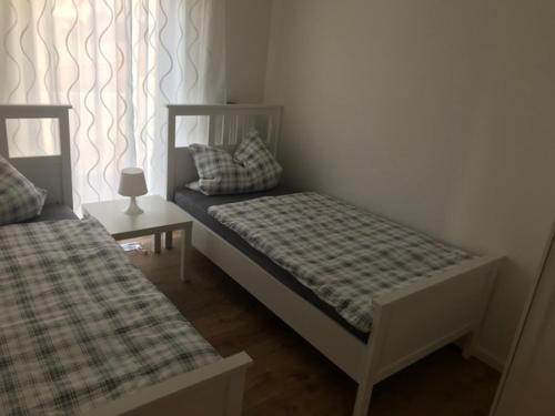 a small bedroom with two beds and a window at Ferienhaus Stricker in Birken-Honigsessen