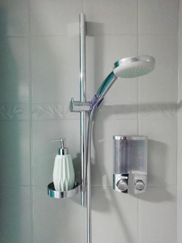 une douche avec pommeau de douche dans une salle de bain dans l'établissement Au pied du télécabine, T3 50m2 pour 8 personnes., à Cauterets